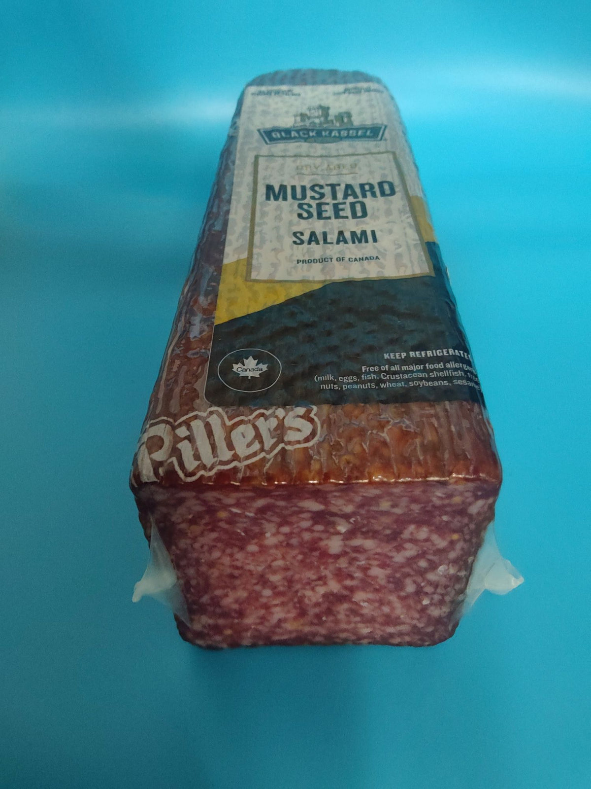 Black Kassel Mustard Seed Dry Aged Salami — the cut face with mustard seed